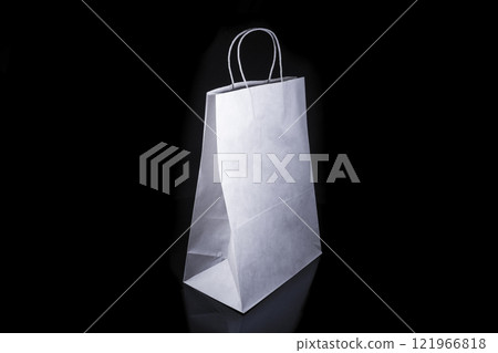 Recyclable craft paper bag for purchases, gifts and takeaway food mock up on black background. Environmentally friendly than single-use plastic bags Recyclable craft paper bag for purchases, gifts and takeaway food mock up on black background. Environmentally friendly than single-use plastic bags 121966818