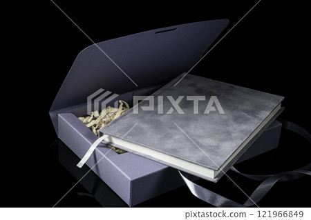 Best gift for men. Man gift concept. Purple notebook with purple gift box on black background. Copy space. Valentine's day, wedding, birthday and special occasion gift concept. Copy space for text. 121966849