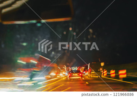 Traffic jam on highway at night with blurred car lights. Concept of urban congestion and nighttime travel 121966886