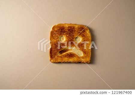 Gluten food, slice of toasted bread with sad face. Gluten allergy Gluten food, slice of toasted bread with sad face. Gluten allergy 121967400