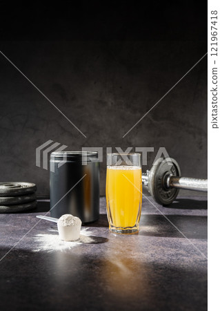 Amino acid food supplement, creatine with orange flavor in a measuring scoop, Sports nutrition  121967418