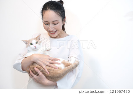 Middle-aged woman holding a cat Middle-aged woman holding a cat 121967450