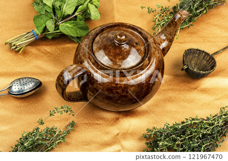 Teapot with herbal tea. 121967470