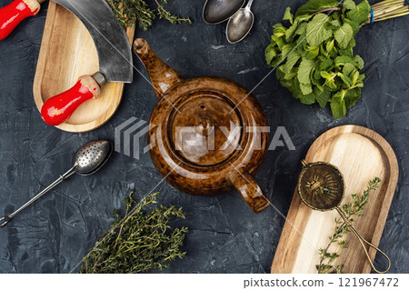 Teapot on table, herbal tea. Teapot on table, herbal tea. 121967472