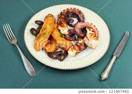 Grilled octopus with roasted baby potatoes. 121967480