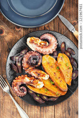 Grilled octopus with roasted baby potatoes. 121967481