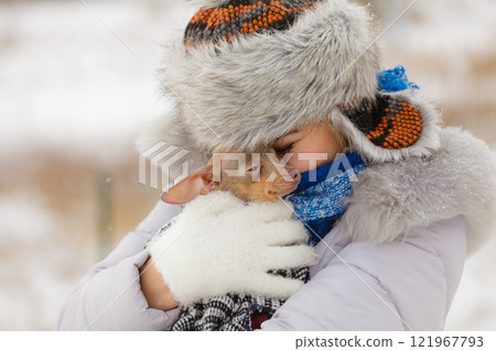 Woman hug warming her little dog in winter 121967793