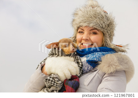 Woman hug warming her dog in cold day Woman hug warming her dog in cold day 121967801