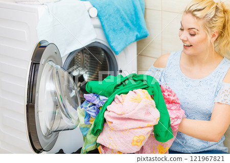 Woman washing colorful laundry Woman washing colorful laundry 121967821