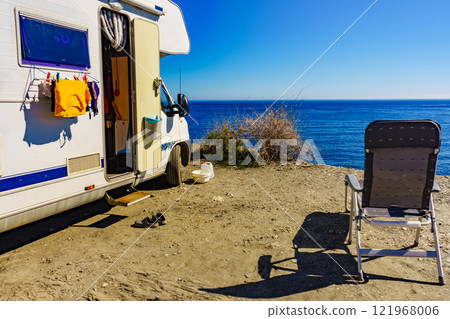 Camper rv on sea with clothes to dry Camper rv on sea with clothes to dry 121968006