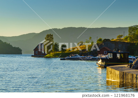Wooden cabin on fjord shore, Norway Wooden cabin on fjord shore, Norway 121968176