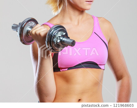 Fit woman lifting dumbbells weights Fit woman lifting dumbbells weights 121968603