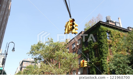 New York City street crossroad, yellow traffic light, transport road intersection, United States. 121968700