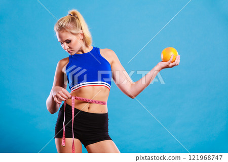 woman fit girl with measure tape and grapefruit woman fit girl with measure tape and grapefruit 121968747