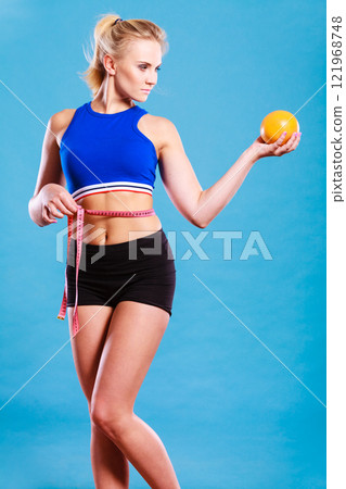 woman fit girl with measure tape and grapefruit woman fit girl with measure tape and grapefruit 121968748
