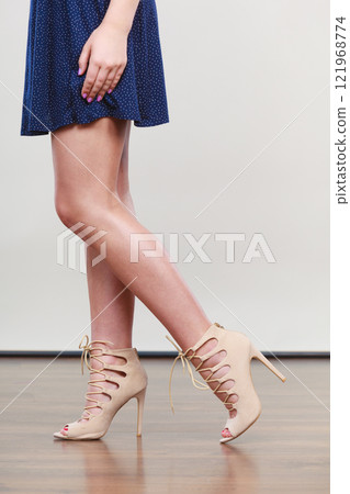 Woman wearing short navy dress and high heels 121968774