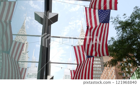 New York, american flag waving. Chrysler building. Manhattan midtown city street banner, patriotism. New York, american flag waving. Chrysler building. Manhattan midtown city street banner, patriotism. 121968840