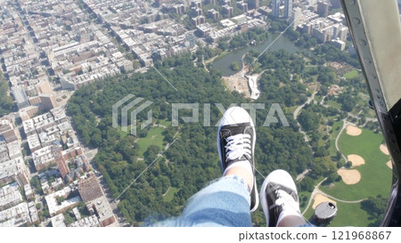 New York City doors off helicopter flight, Manhattan USA. Feet in sneakers, legs in shoes selfie pov 121968867