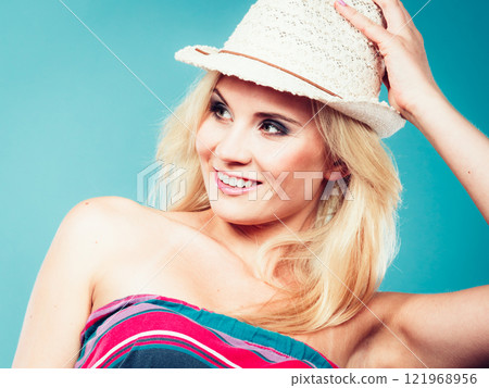 Blonde woman wearing colorful striped strapless shirt 121968956