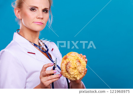 dietitian examine sweet roll bun with stethoscope 121968975