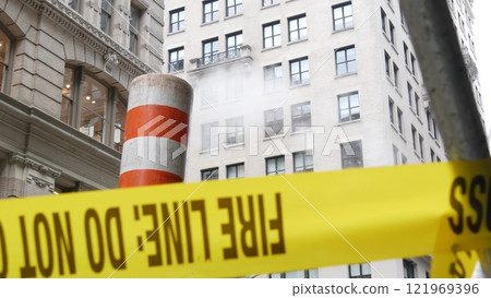 Steam vapor vented, New York City street steam system, orange vapour tube stack. Hot smoke from pipe 121969396