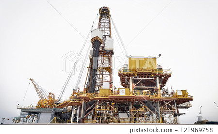A large oil rig with a crane on top of it 121969758
