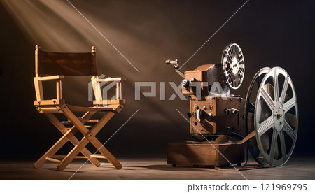 A wooden chair and a projector are on a dark background 121969795