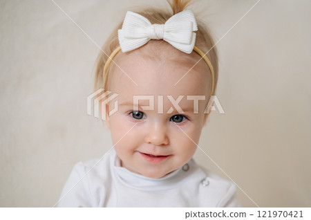 close up of laughing happy child in white clothes, little smiling girl close up of laughing happy child in white clothes, little smiling girl 121970421