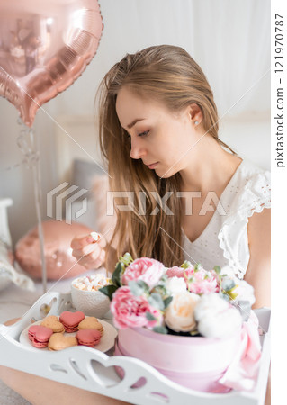 Beautiful young girl at home on the bed in the morning enjoy breakfast and valentines day celebration with heart shaped balloons Beautiful young girl at home on the bed in the morning enjoy breakfast and valentines day celebration with heart shaped balloons 121970787