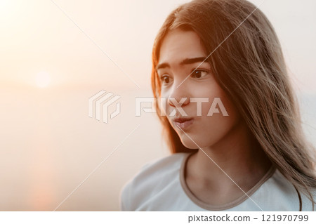 Portrait of a Young Girl Contemplating at Sunset Portrait of a Young Girl Contemplating at Sunset 121970799
