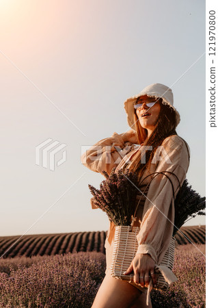 Young Woman in Lavender Field with a Basket of Flowers Young Woman in Lavender Field with a Basket of Flowers 121970800