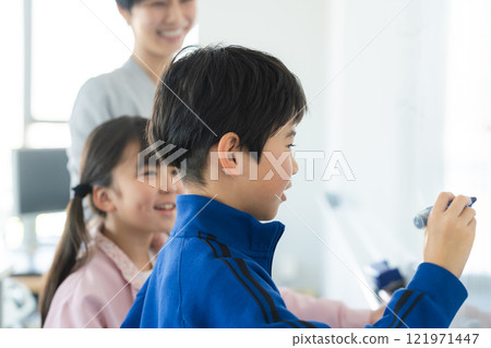 Elementary school students taking lessons in a classroom Elementary school students taking lessons in a classroom 121971447