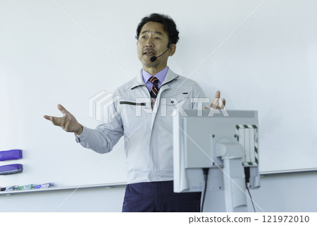 穿著工作服的中年男子在白板前說話 攝影合作：電波學園教育法人東京電子學校。 121972010