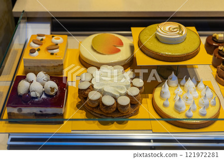 Assortment of cakes displayed in bakery. Concept of luxury desserts and culinary craftsmanship Assortment of cakes displayed in bakery. Concept of luxury desserts and culinary craftsmanship 121972281