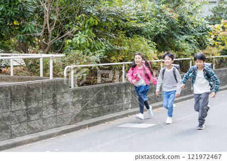 Elementary school students going to and from school 121972467