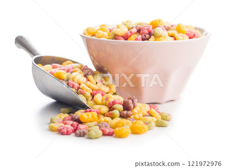 Colorful breakfast cereals in the shape of various fruit in scoop isolated on white background. Colorful breakfast cereals in the shape of various fruit in scoop isolated on white background. 121972976