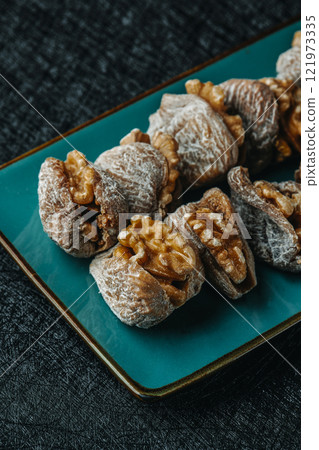dried figs filled with walnuts on a plate dried figs filled with walnuts on a plate 121973335