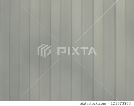 gray textured background with vertical stripes and softened sharpness, fragment of galvanized metal sheet with convex grooves, part of iron fence as design backdrop 121973593