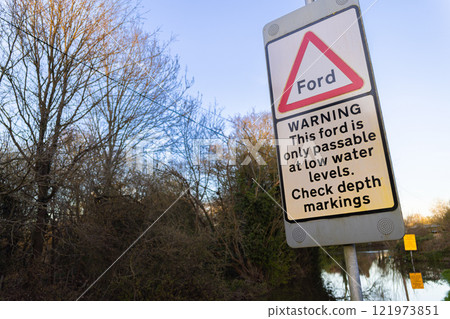 Flood Warning Sign With a Flooded Ford in England, United Kingdom Flood Warning Sign With a Flooded Ford in England, United Kingdom 121973851