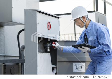 Building maintenance staff inspecting outdoor fire hydrant equipment Building maintenance staff inspecting outdoor fire hydrant equipment 121973878