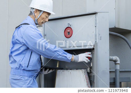 Man in work clothes inspecting outdoor fire hydrant equipment Building maintenance image Man in work clothes inspecting outdoor fire hydrant equipment Building maintenance image 121973948