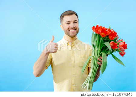 Man holding bouquet of red tulips 121974345