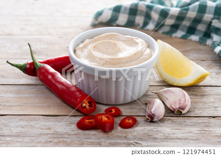 Traditional mexican sauce with spices and pepper on wooden table 121974451