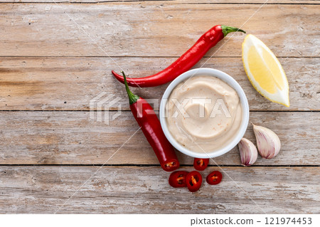 Traditional mexican sauce with spices and pepper on wooden table 121974453