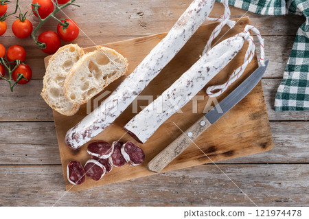 Fuet.Dry cured fuet sausage on wooden table 121974478