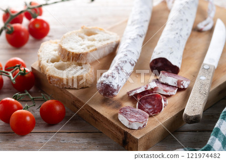 Fuet.Dry cured fuet sausage on wooden table 121974482