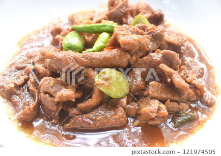 spicy stir fried slice pork with stink bean and chili in shrimp paste sauce on plate spicy stir fried slice pork with stink bean and chili in shrimp paste sauce on plate 121974505