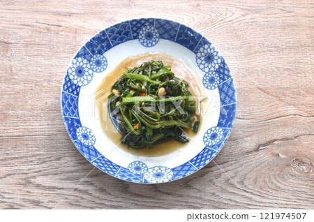 stir fried slice Chinese morning glory with chili on plate  121974507