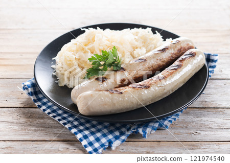Bratwurst sausage and sauerkraut on wooden table Bratwurst sausage and sauerkraut on wooden table 121974540