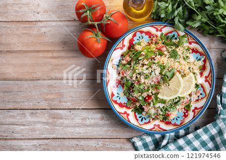 Tabbouleh salad with couscous on wooden table 121974546